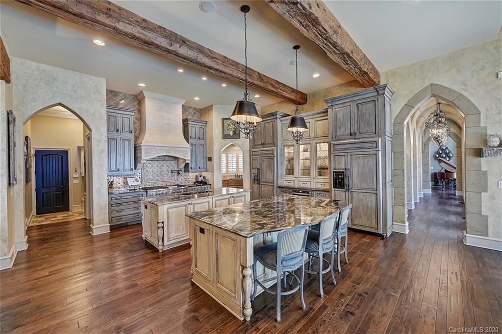 16505 Jetton Road Cornelius, NC 28031 - Photo 16 of 48 a kitchen with stainless steel appliances granite countertop a stove oven and a refrigerator