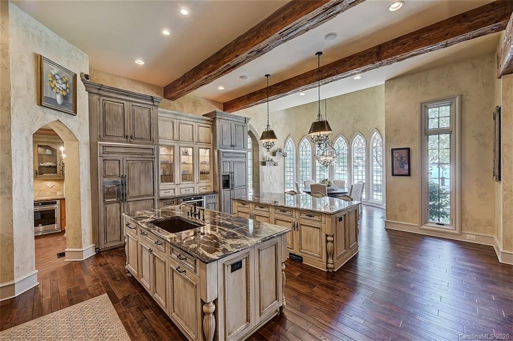 16505 Jetton Road Cornelius, NC 28031 - Photo 17 of 48 a kitchen with stainless steel appliances granite countertop a stove and a refrigerator