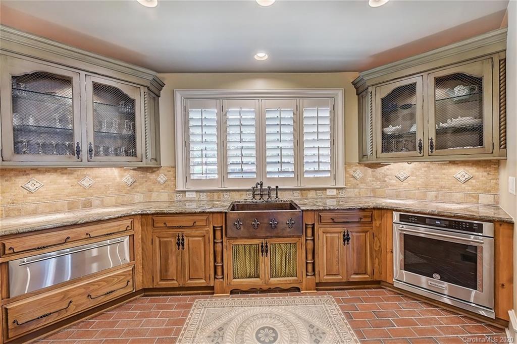 16505 Jetton Road Cornelius, NC 28031 - Photo 18 of 48 a kitchen with stainless steel appliances granite countertop a stove and cabinets