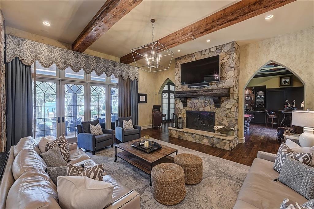 16505 Jetton Road Cornelius, NC 28031 - Photo 20 of 48 a living room with furniture a flat screen tv and a fireplace