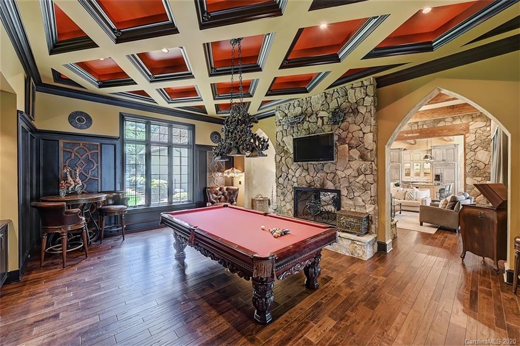 16505 Jetton Road Cornelius, NC 28031 - Photo 23 of 48 a living room with furniture pool table wooden floor and windows