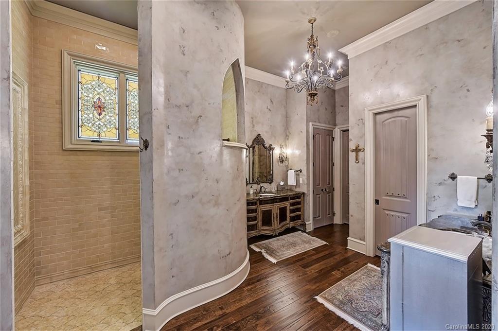 16505 Jetton Road Cornelius, NC 28031 - Photo 29 of 48 a spacious bathroom with a granite countertop sink a large mirror and a shower