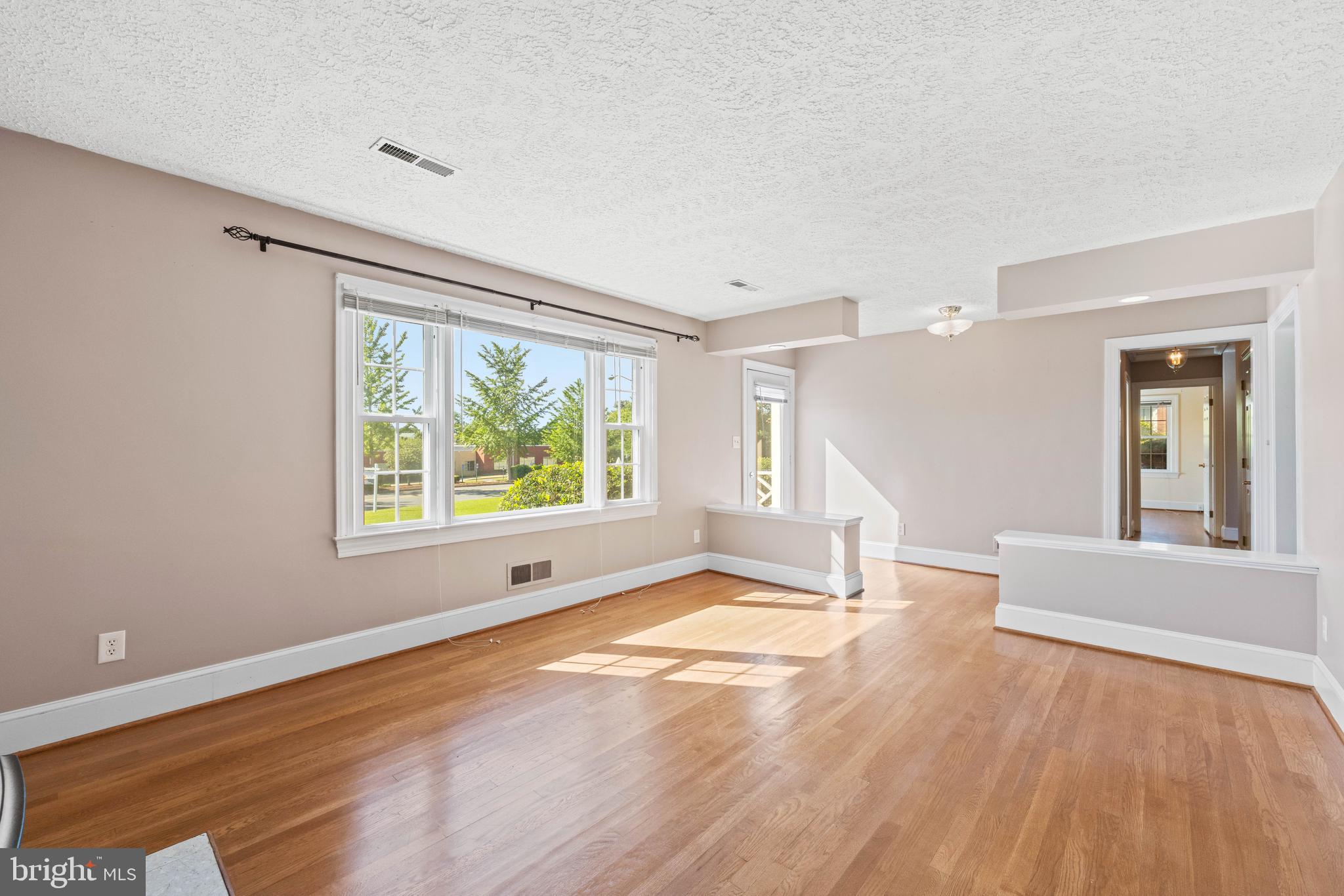 650 Yowell Drive Culpeper, VA 22701 - Photo 17 of 65 a view of an empty room with wooden floor and a window