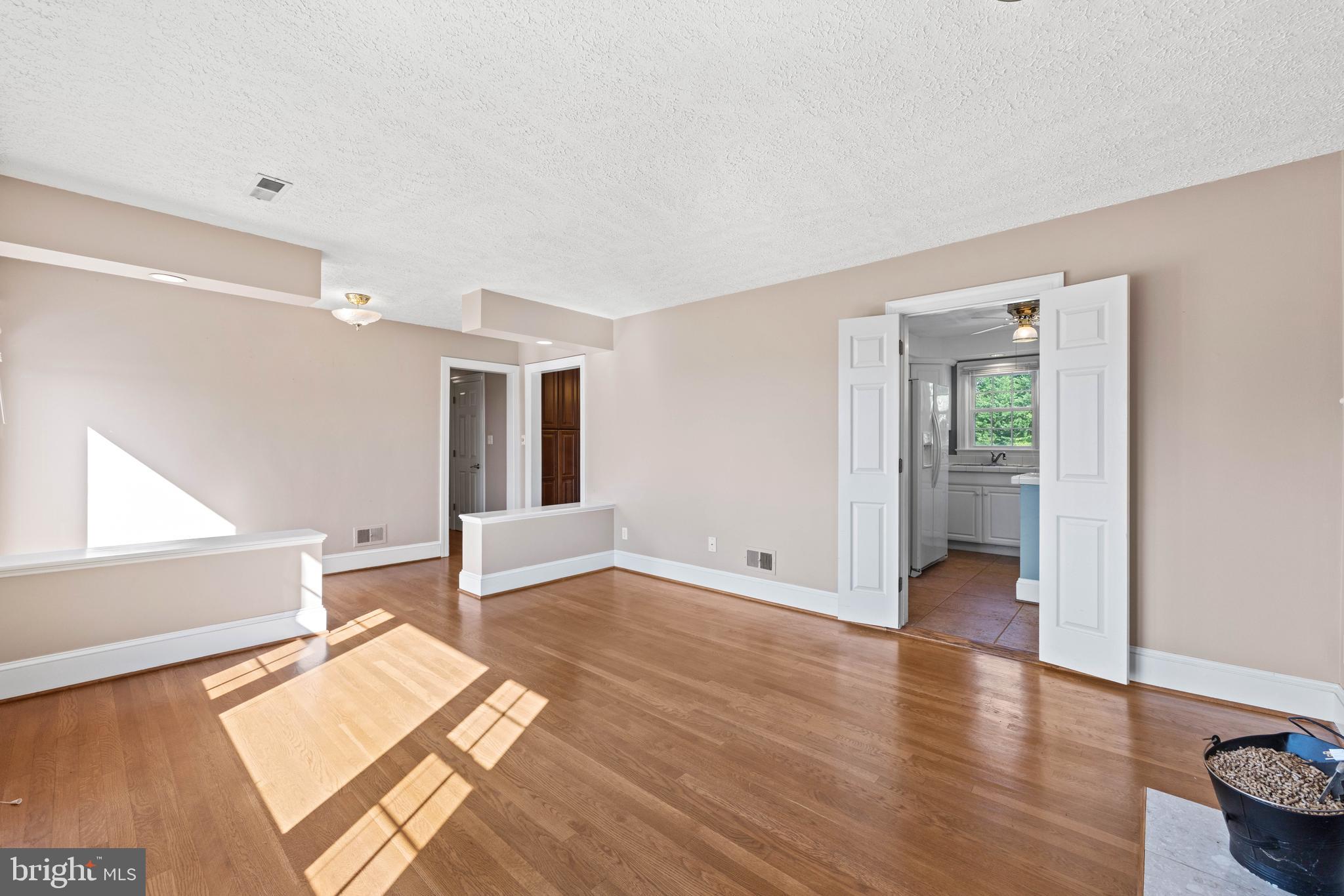 650 Yowell Drive Culpeper, VA 22701 - Photo 18 of 65 a view of an empty room with window and wooden floor