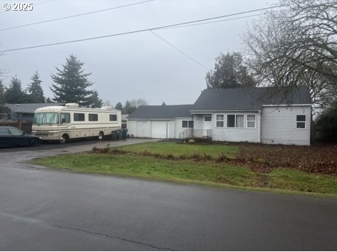 a front view of a house with a garden and yard