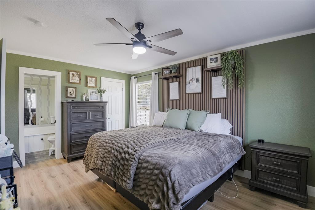 472 Cox Road Waxahachie, TX 75167 - Photo 6 of 31 Wood-finish flooring with a ceiling fan, accent wall with shelving, and built-in vanity area