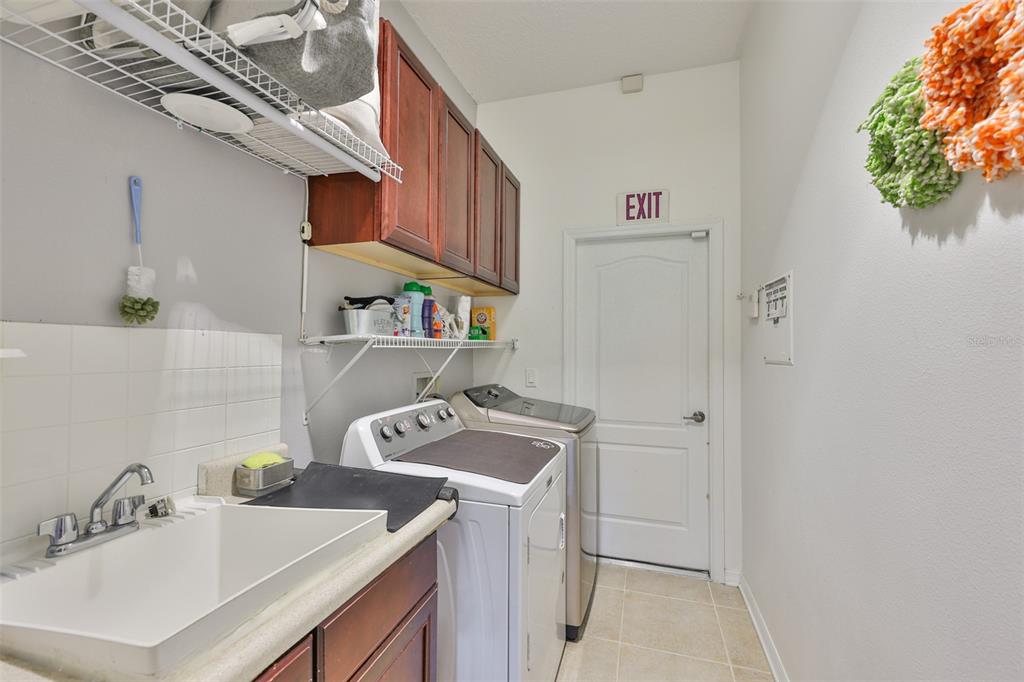 1204 Facet View Way Valrico, FL 33594 - Photo 12 of 59 a utility room with sink dryer and washer
