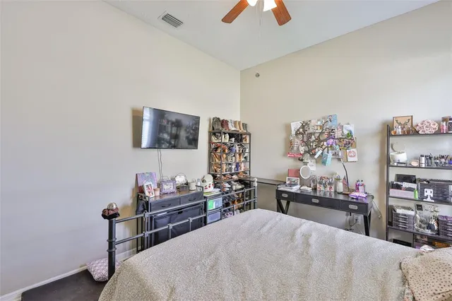 a bedroom with a bed and a chandelier