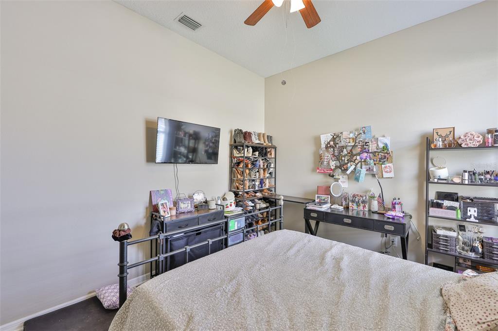 1204 Facet View Way Valrico, FL 33594 - Photo 15 of 59 a bedroom with a bed and a flat tv screen in it