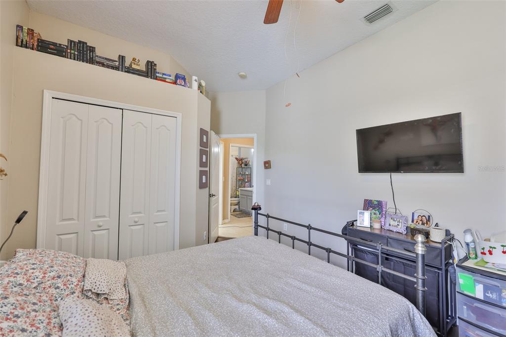 1204 Facet View Way Valrico, FL 33594 - Photo 16 of 59 a bedroom with a bed and a flat screen tv