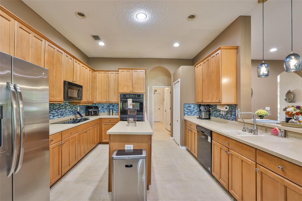 1204 Facet View Way Valrico, FL 33594 - Photo 23 of 59 a large kitchen with stainless steel appliances lots of counter space and windows