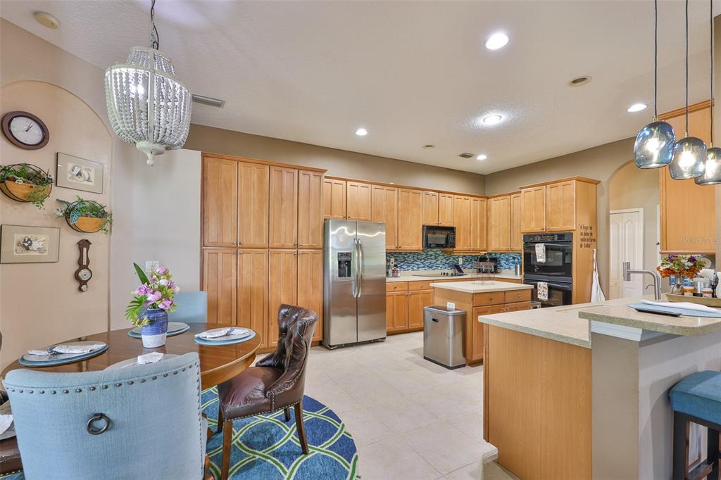 1204 Facet View Way Valrico, FL 33594 - Photo 25 of 59 a open kitchen with stainless steel appliances granite countertop a sink dishwasher a refrigerator and a dining table with the kitchen view