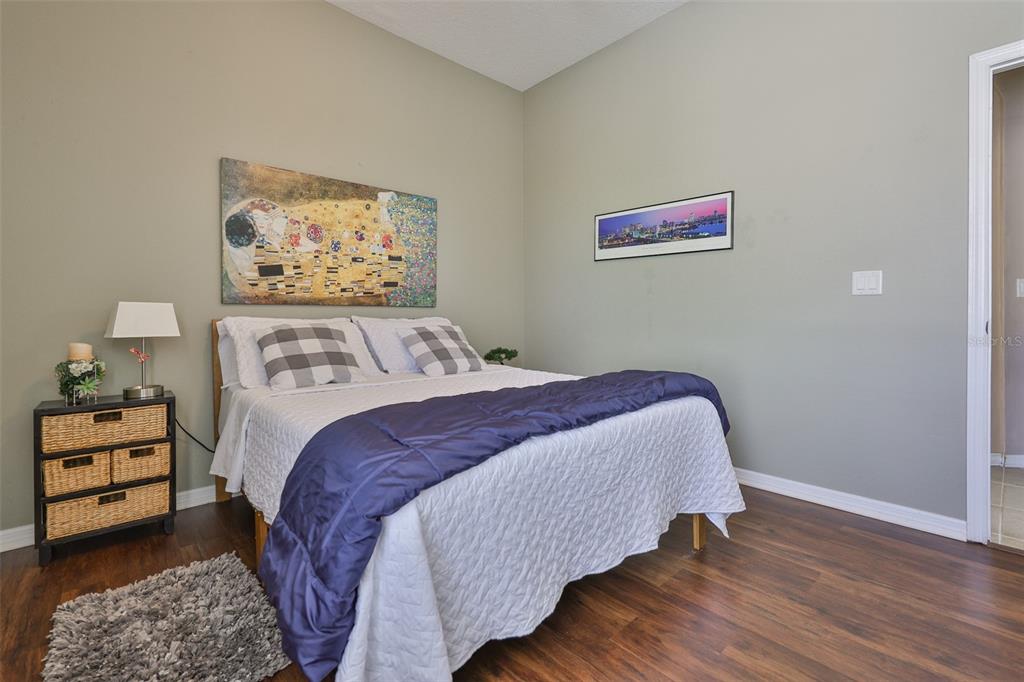 1204 Facet View Way Valrico, FL 33594 - Photo 40 of 59 a bedroom with a bed and painting on the wall