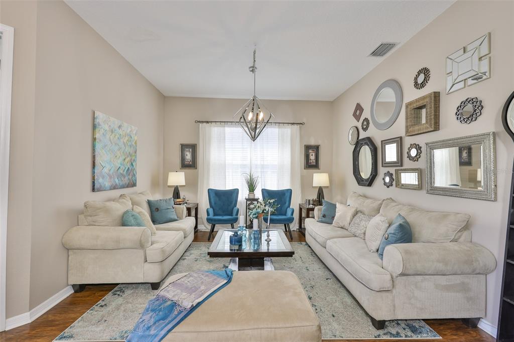 1204 Facet View Way Valrico, FL 33594 - Photo 4 of 59 a living room with furniture and a chandelier