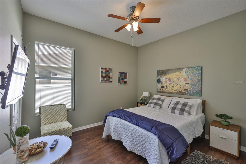 1204 Facet View Way Valrico, FL 33594 - Photo 42 of 59 a bedroom with a bed and a chandelier