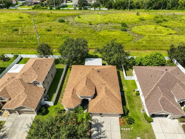 an aerial view of a house with garden space and ocean view