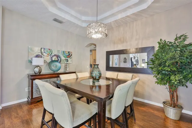 a view of a dining room with furniture wooden floor and chandelier