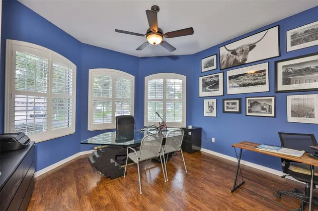 a view of a dining room with furniture a chandelier and wooden floor