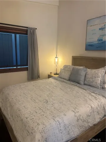 a large bed sitting in a bedroom next to a cabinet