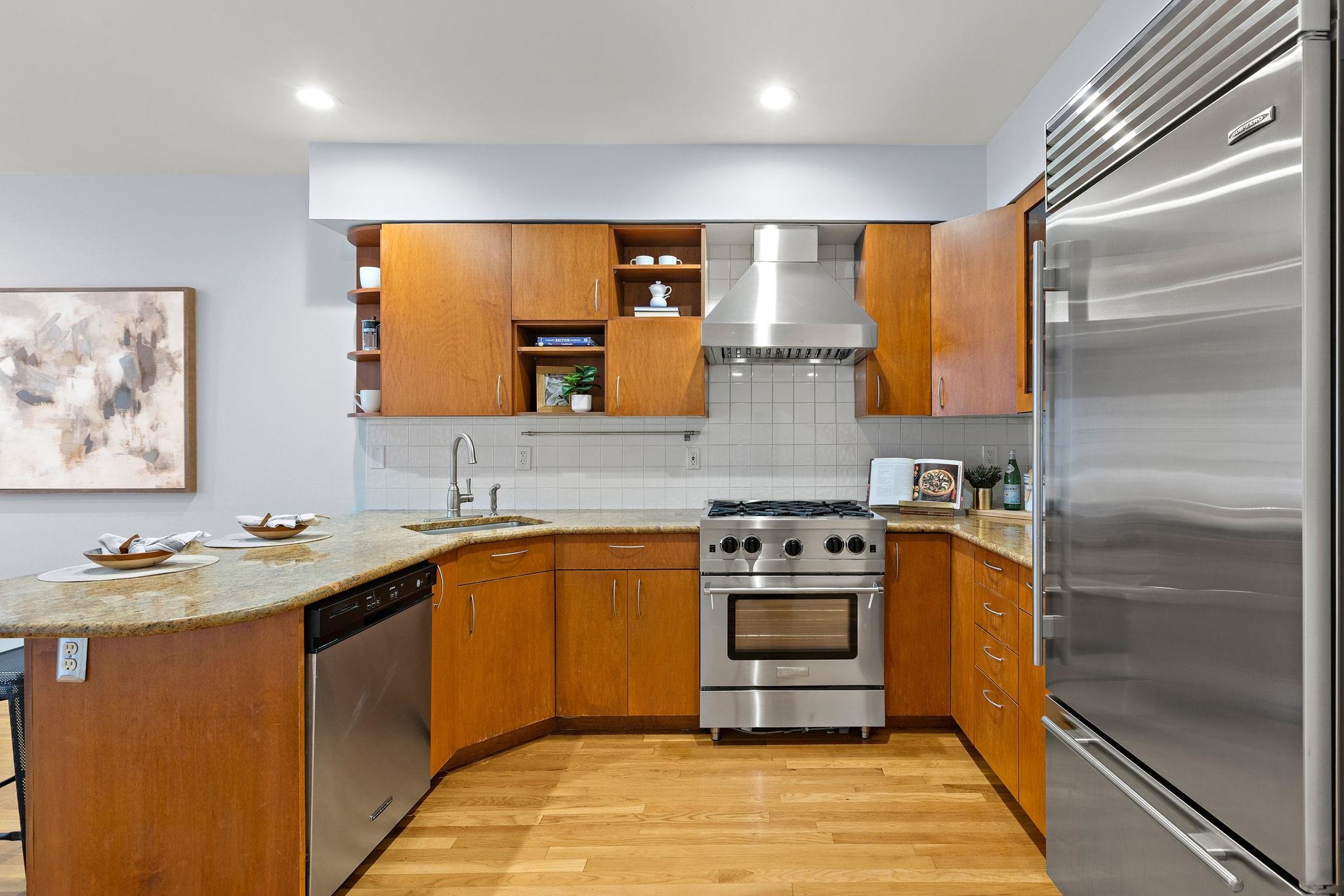 95 Garden Street, Unit 3A Hoboken, NJ 07030 - Photo 12 of 22 a kitchen with stainless steel appliances granite countertop a sink stove and refrigerator