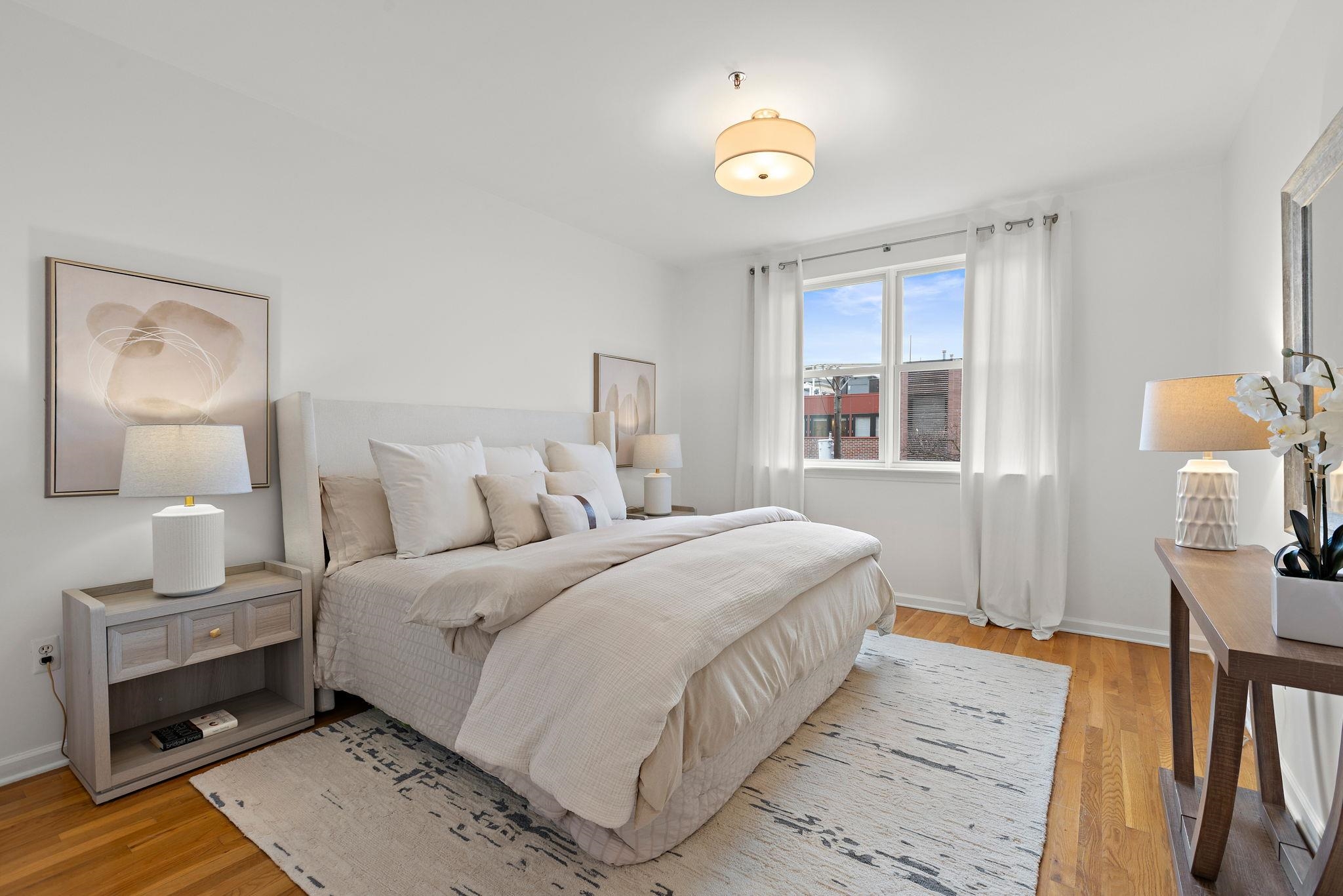 95 Garden Street, Unit 3A Hoboken, NJ 07030 - Photo 13 of 22 a bedroom with a bed and a lamp on table