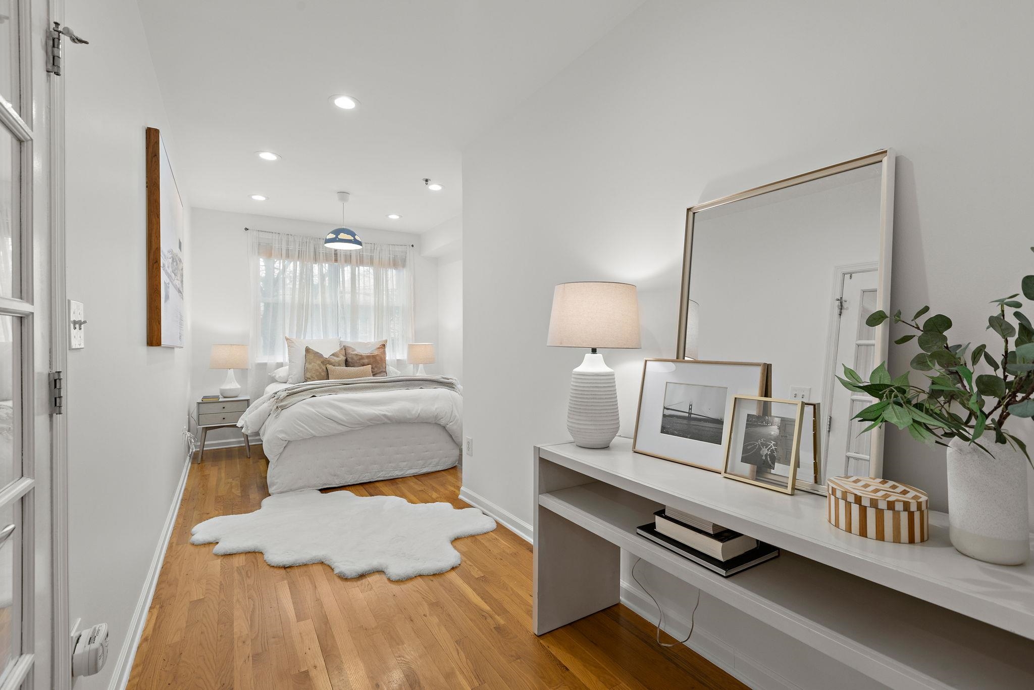 95 Garden Street, Unit 3A Hoboken, NJ 07030 - Photo 16 of 22 a bedroom with a bed and wooden floor