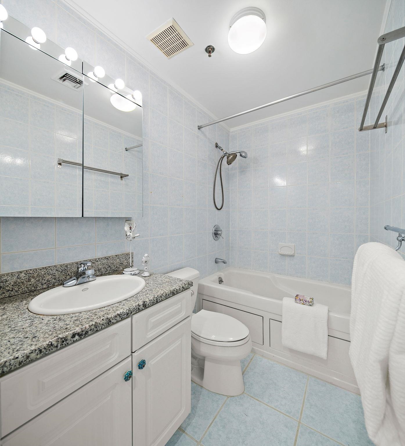 95 Garden Street, Unit 3A Hoboken, NJ 07030 - Photo 20 of 22 a bathroom with a sink a toilet and a large mirror