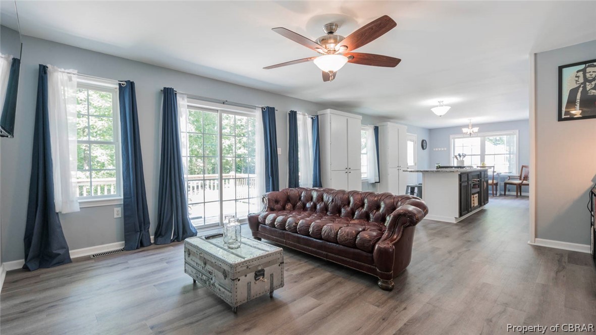4555 Good Hope Road Lanexa, VA 23089 - Photo 11 of 49 Lots of windows & sliding glass door to be able to enjoy the large deck overlooking the wooded backyard.