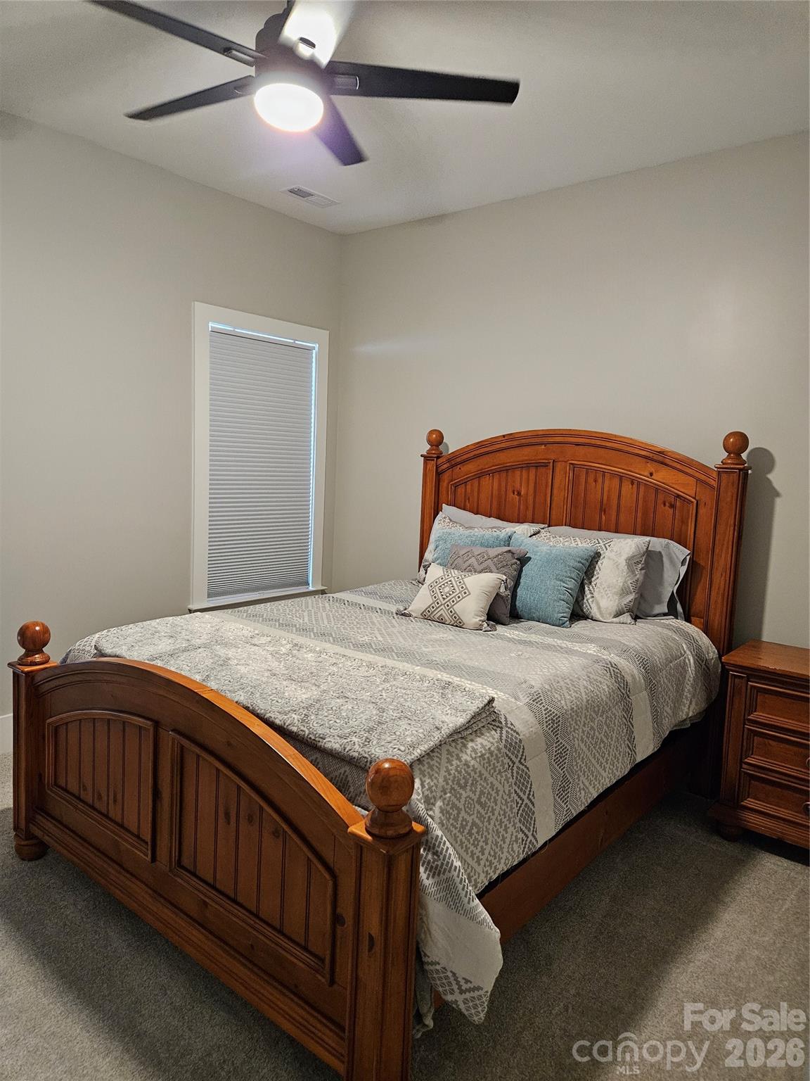 6512 Medlin Road Monroe, NC 28112 - Photo 19 of 28 a bedroom with a bed and a chandelier