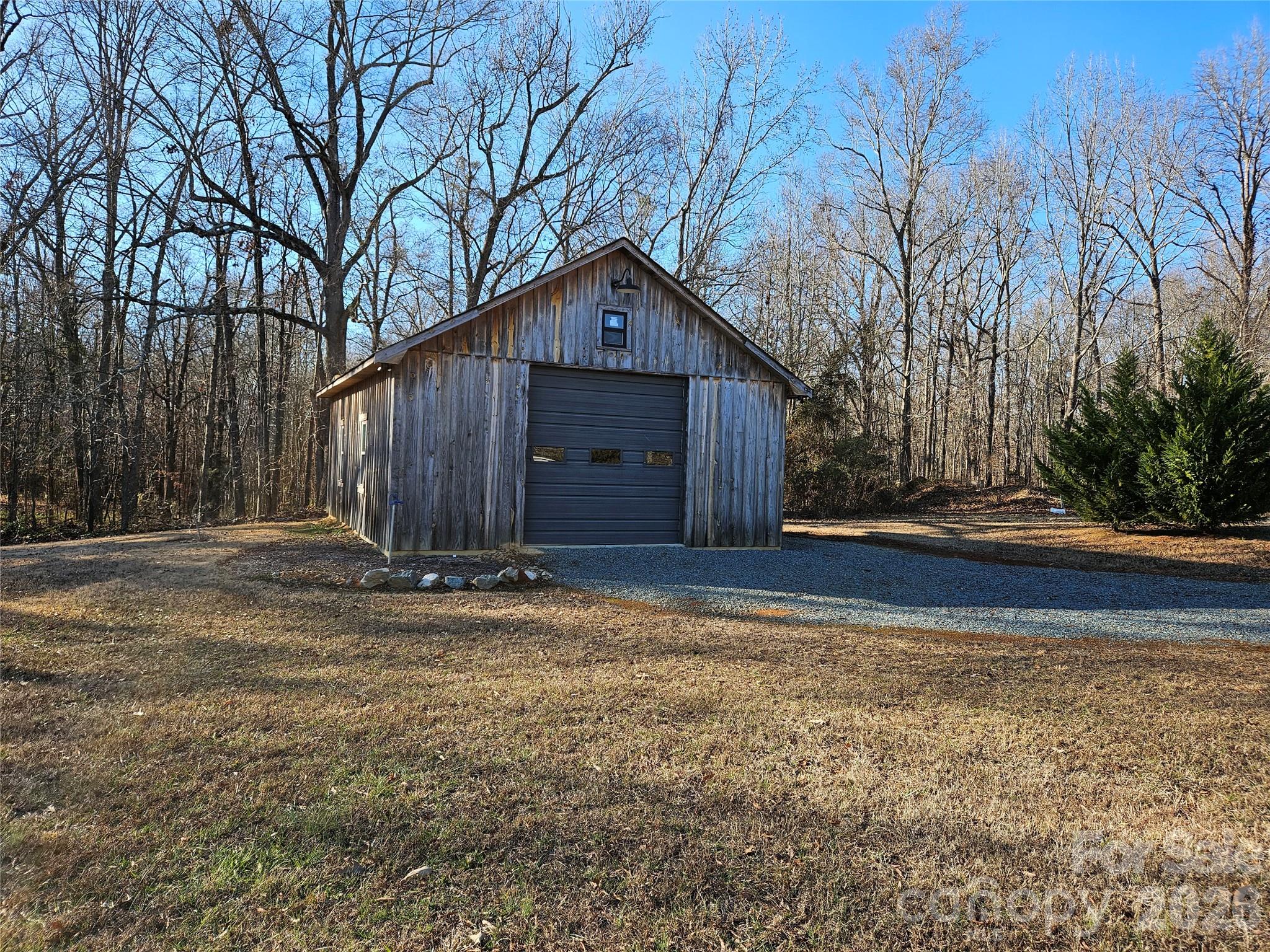 6512 Medlin Road Monroe, NC 28112 - Photo 26 of 28 a wooden house with trees in front of it