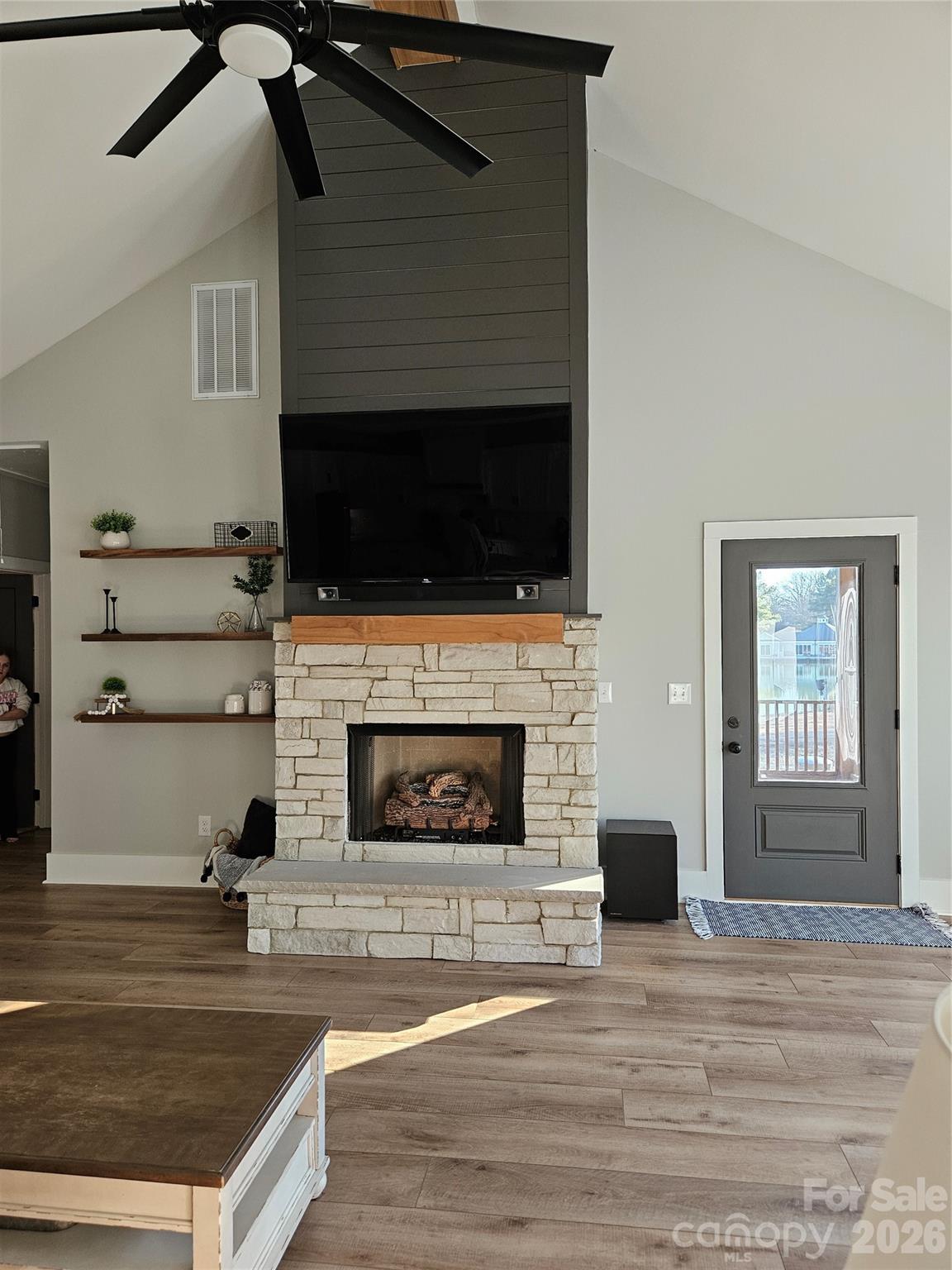 6512 Medlin Road Monroe, NC 28112 - Photo 4 of 28 a living room with furniture a flat screen tv and a fireplace