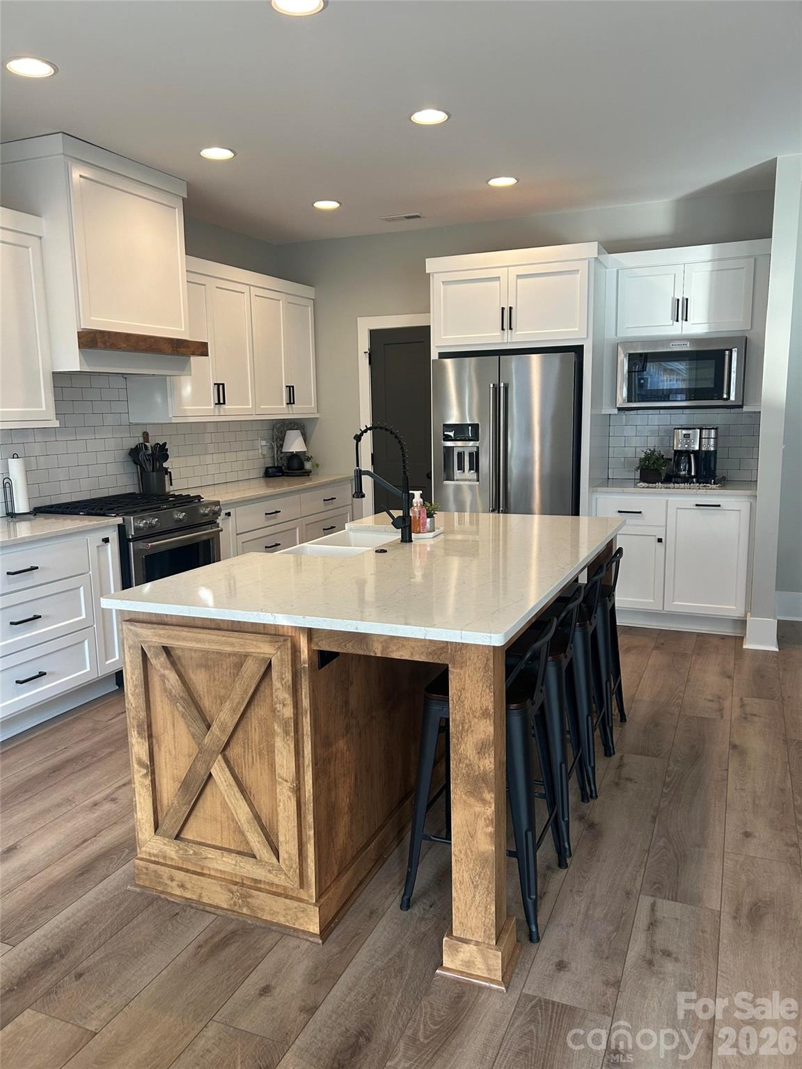 6512 Medlin Road Monroe, NC 28112 - Photo 8 of 28 a kitchen with stainless steel appliances granite countertop a table chairs sink refrigerator and microwave
