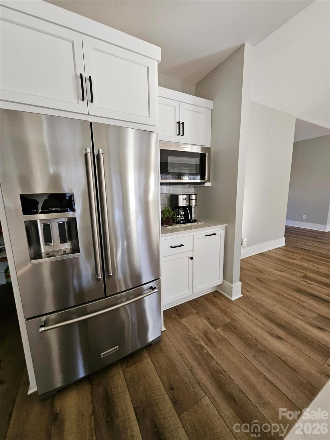 6512 Medlin Road Monroe, NC 28112 - Photo 9 of 28 a kitchen with stainless steel appliances a refrigerator sink and microwave