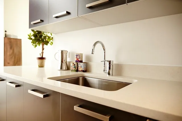 a kitchen with a refrigerator a stove and a window