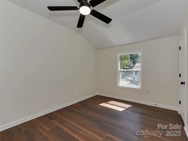 a view of a big room with wooden floor and a ceiling fan