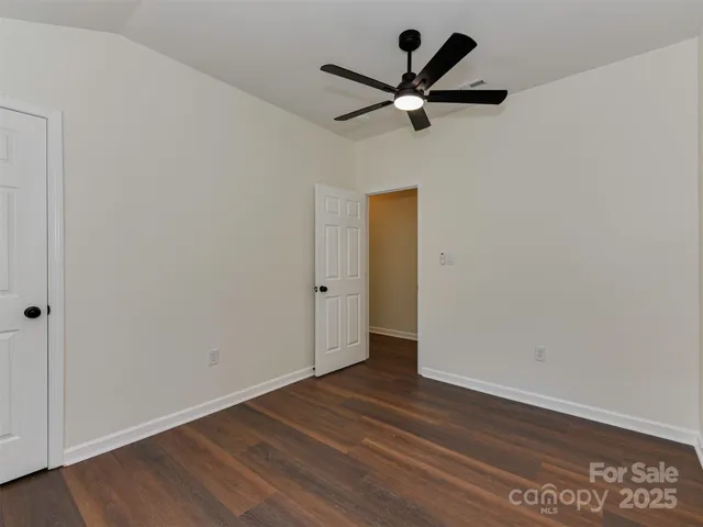 a bathroom with a granite countertop bathtub shower sink vanity and toilet