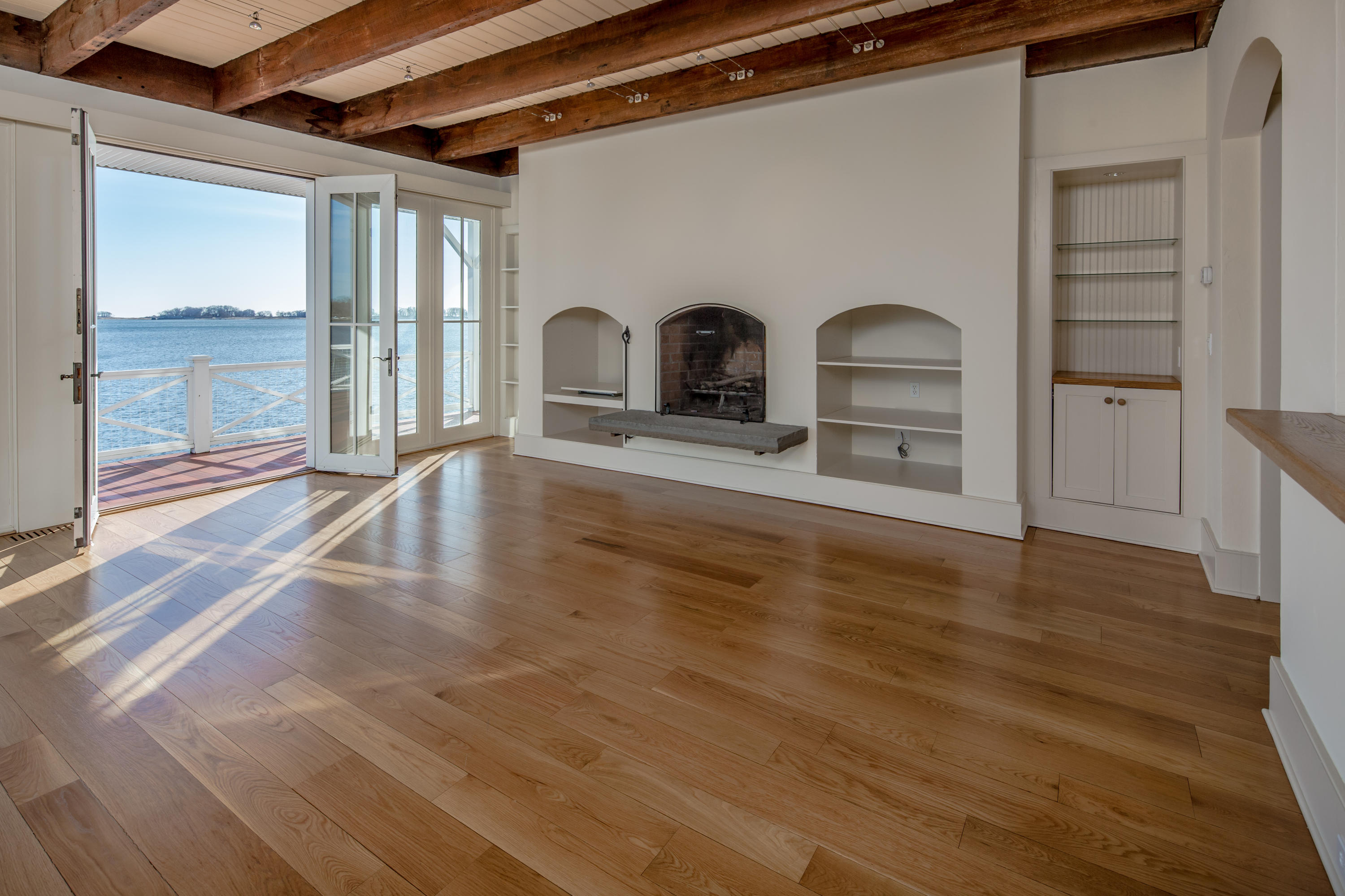 1-2 Rocky Point Road Rowayton, CT 06853 - Photo 12 of 38 a view of empty room with wooden floor and fan