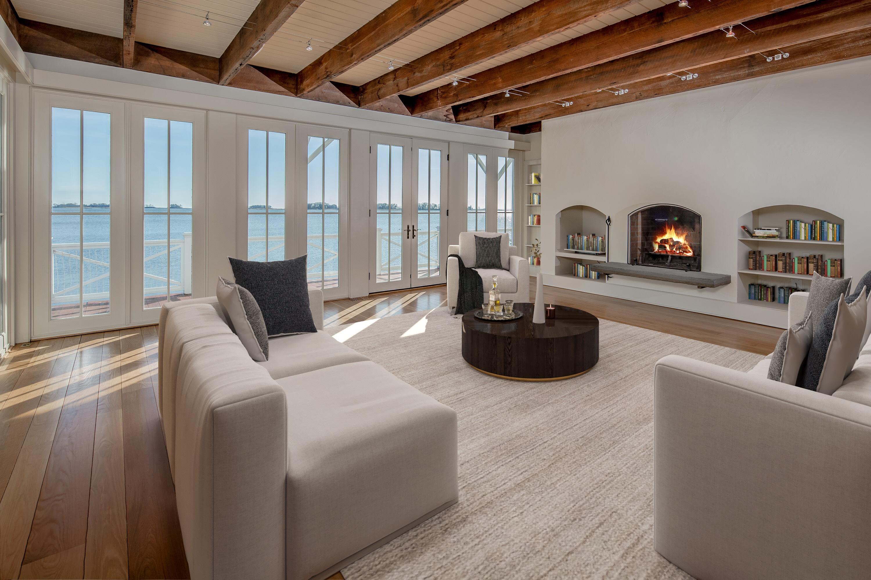 1-2 Rocky Point Road Rowayton, CT 06853 - Photo 15 of 38 a living room with furniture a fireplace and a floor to ceiling window