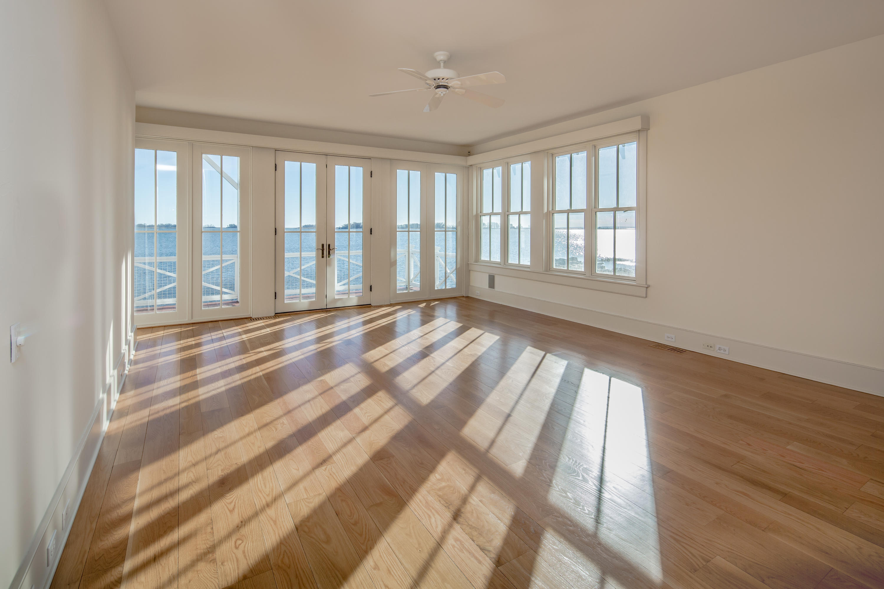 1-2 Rocky Point Road Rowayton, CT 06853 - Photo 16 of 38 a view of an empty room with wooden floor and a window
