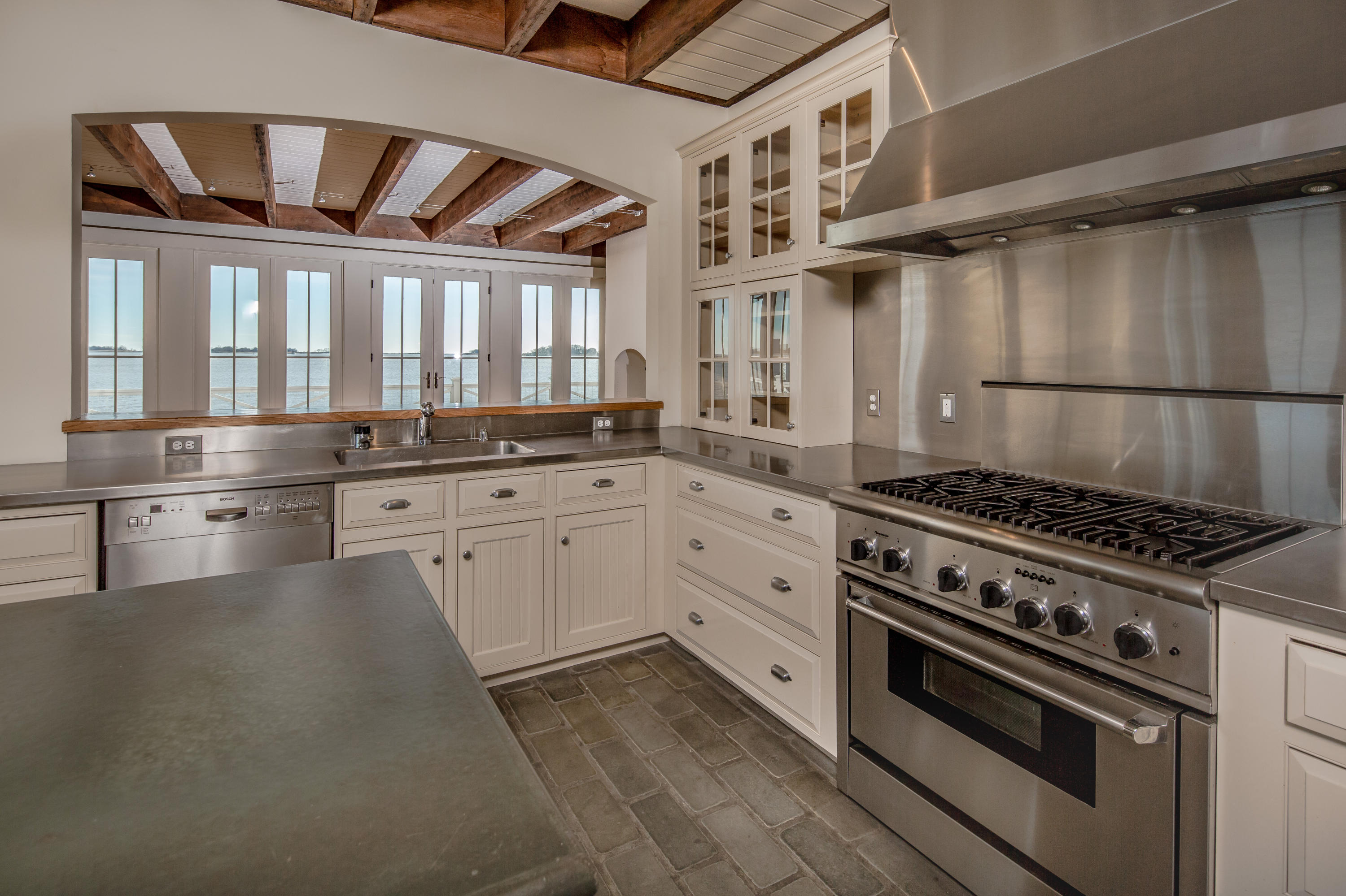 1-2 Rocky Point Road Rowayton, CT 06853 - Photo 24 of 38 a kitchen with stainless steel appliances a stove a sink and cabinets