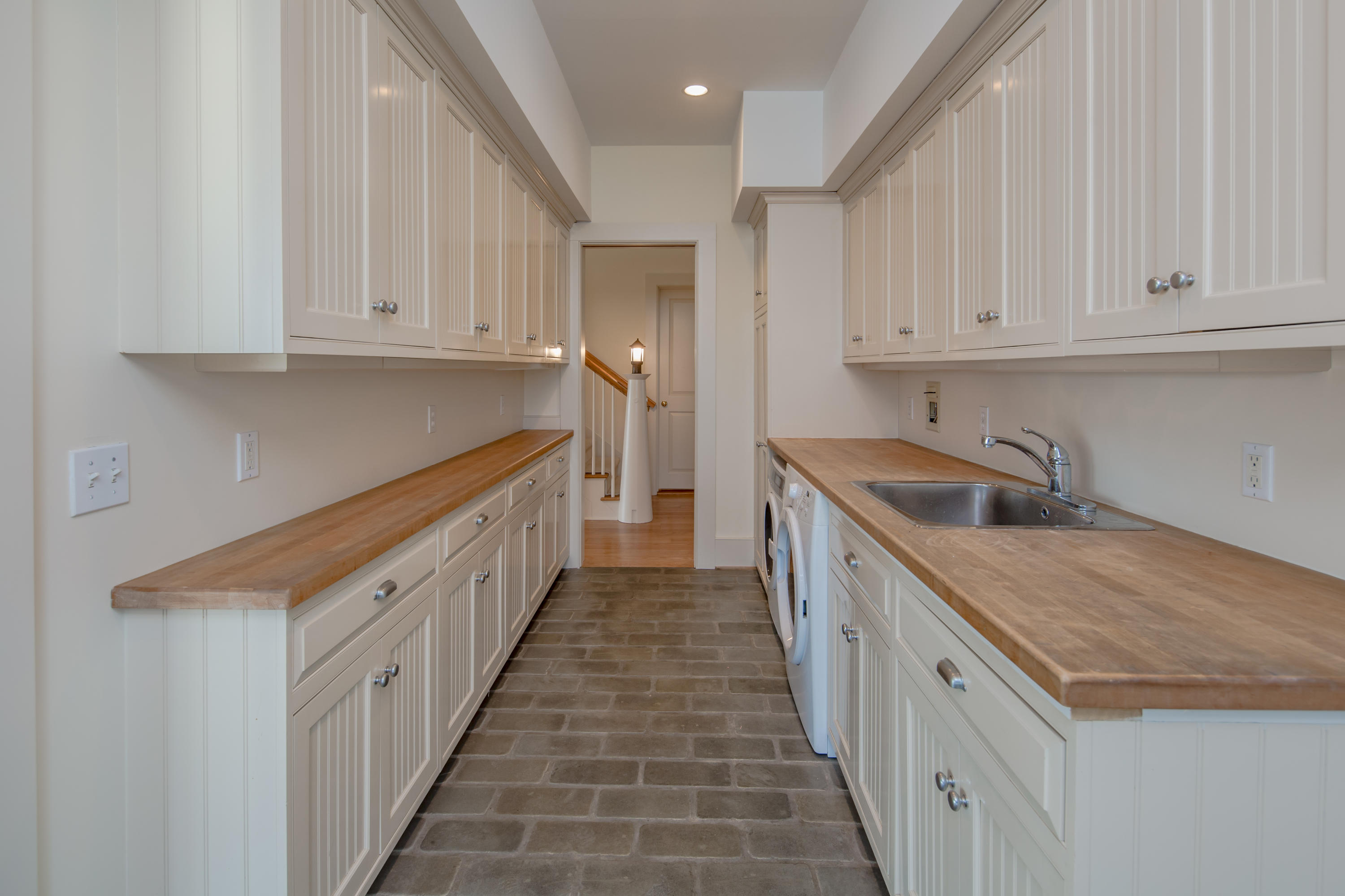 1-2 Rocky Point Road Rowayton, CT 06853 - Photo 25 of 38 a kitchen with granite countertop a sink and dishwasher a stove top oven with white cabinets