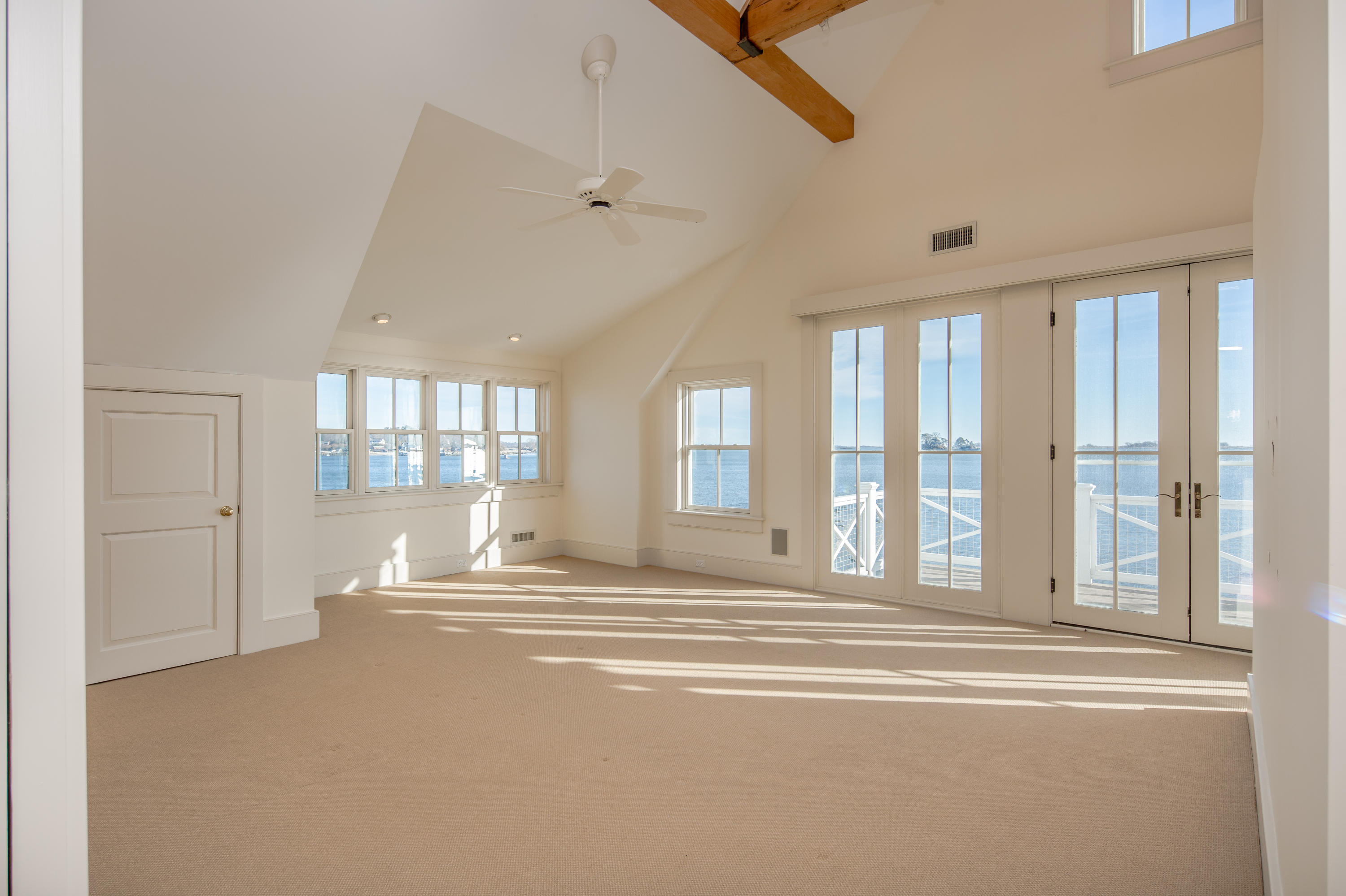 1-2 Rocky Point Road Rowayton, CT 06853 - Photo 27 of 38 a view of empty room with wooden floor and fan