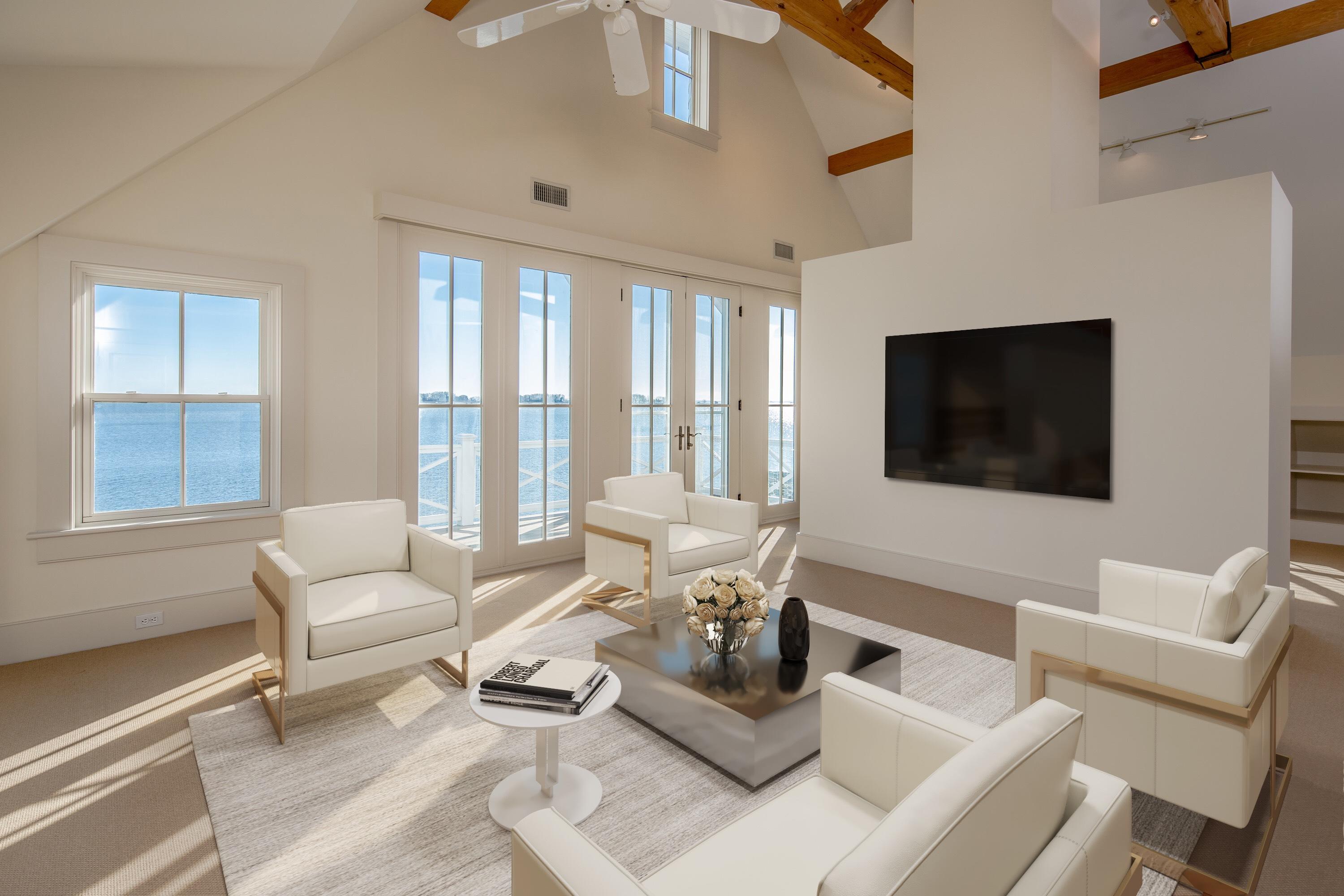 1-2 Rocky Point Road Rowayton, CT 06853 - Photo 28 of 38 a living room with furniture a flat screen tv and a floor to ceiling window