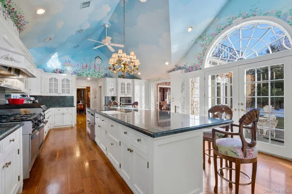 a kitchen with stainless steel appliances granite countertop a stove and cabinets