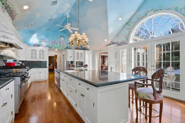 a kitchen with stainless steel appliances granite countertop a stove and cabinets