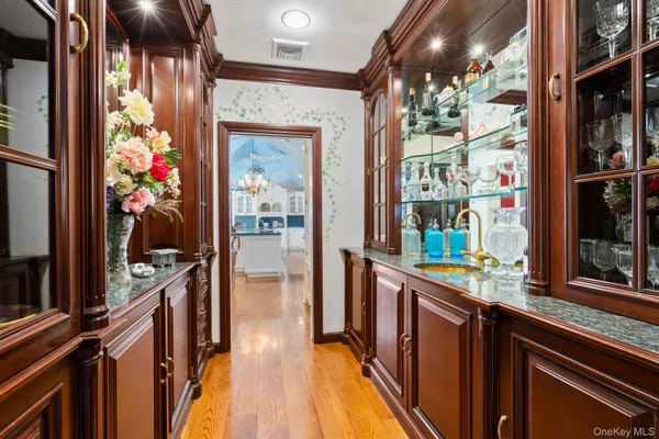 a living room with furniture large windows and wooden floor