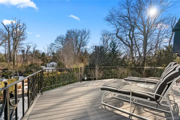 a spacious bathroom with a tub sink and mirror
