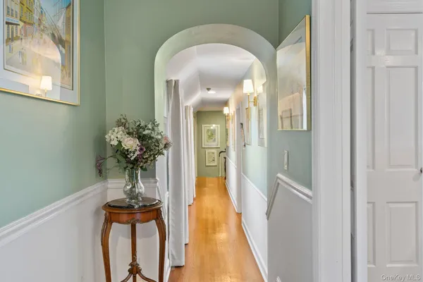 a living room with furniture and a wall painting