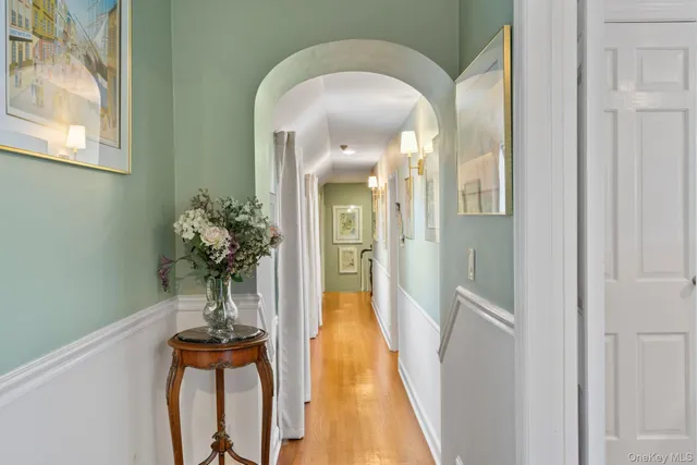 a living room with furniture and a wall painting