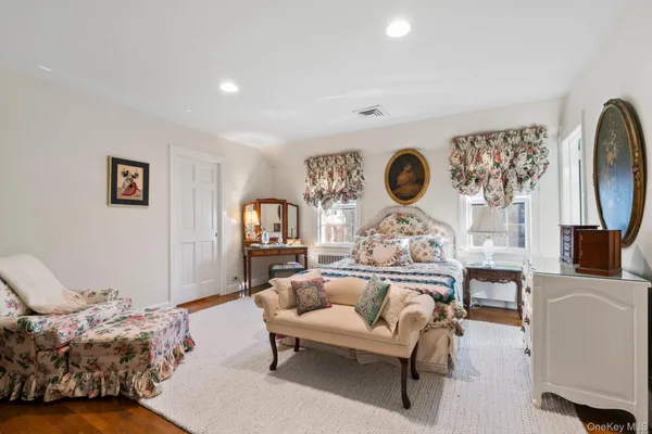 a spacious bedroom with a bed and a table in it